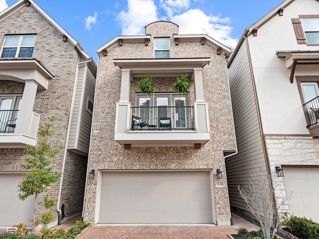 multi unit property featuring a balcony and a garage