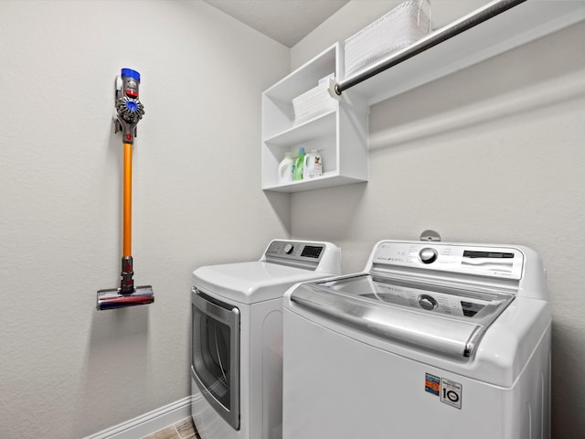 clothes washing area featuring washer and dryer