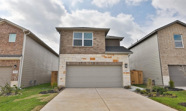 traditional-style house with a garage, stone siding, concrete driveway, and a shingled roof