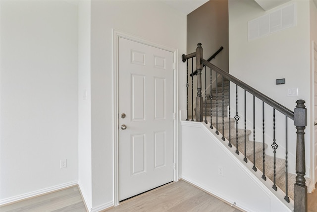 entrance foyer featuring visible vents, baseboards, and light wood finished floors