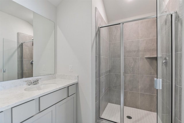 full bathroom with a stall shower and vanity