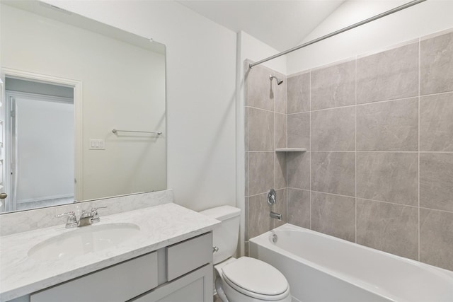 full bath featuring vanity, bathing tub / shower combination, toilet, and vaulted ceiling