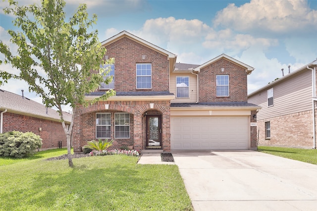 view of front property featuring a garage and a front yard