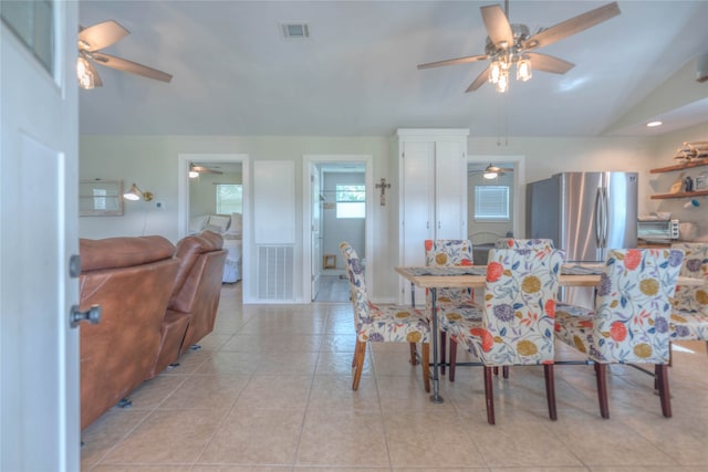 tiled dining space with vaulted ceiling