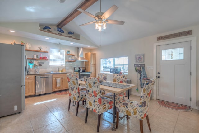 dining room with sink, lofted ceiling with beams, ceiling fan, and light tile patterned flooring