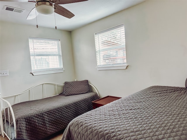 bedroom featuring multiple windows and ceiling fan