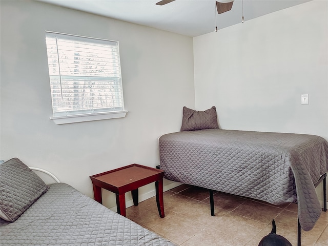 bedroom with ceiling fan and light tile patterned floors