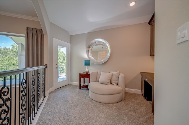 living area with light colored carpet and ornamental molding