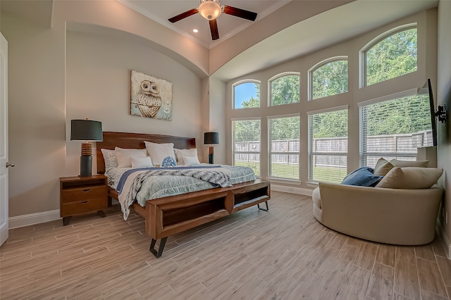 bedroom featuring multiple windows, ceiling fan, and light hardwood / wood-style flooring