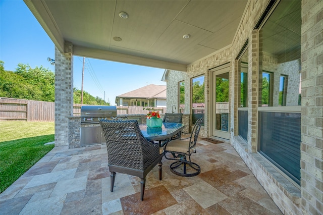 view of patio / terrace with area for grilling and a grill