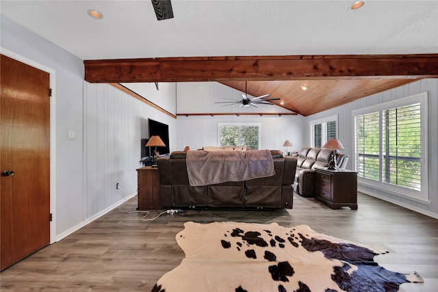 bedroom with hardwood / wood-style floors, lofted ceiling with beams, and a textured ceiling