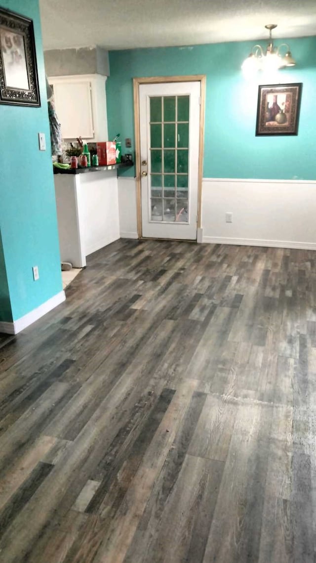 unfurnished living room with dark hardwood / wood-style floors