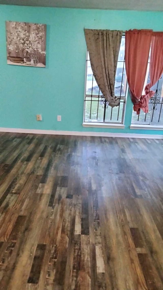 unfurnished room featuring dark hardwood / wood-style floors