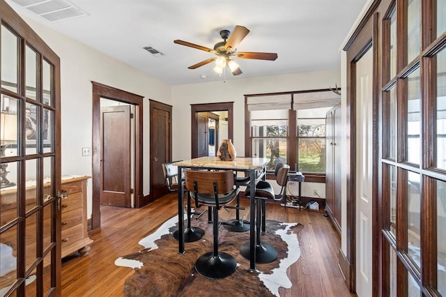 dining room featuring french doors, dark hardwood / wood-style floors, and ceiling fan