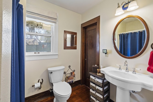 bathroom with sink, hardwood / wood-style floors, and toilet