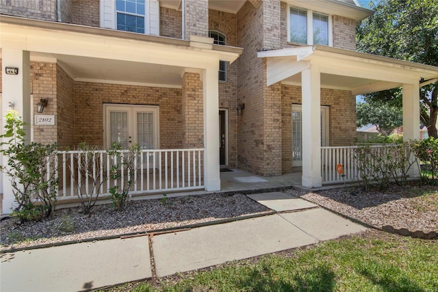 view of exterior entry with covered porch