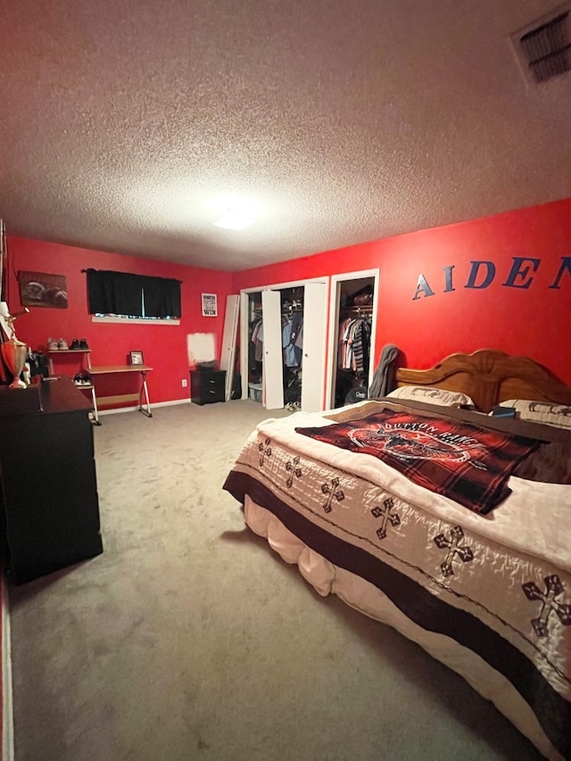 bedroom with a textured ceiling and carpet floors