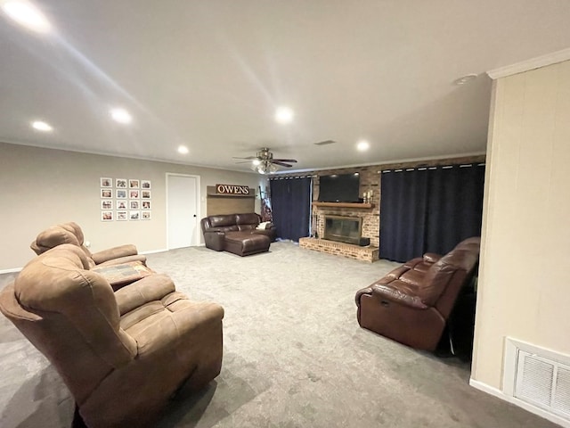 carpeted living room featuring ceiling fan and a fireplace