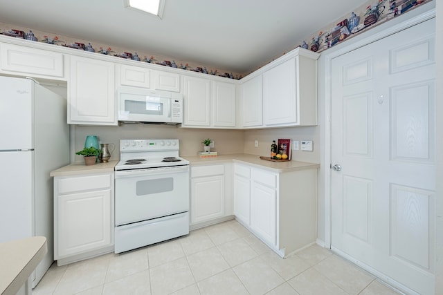 kitchen with light tile patterned flooring, white appliances, and white cabinetry