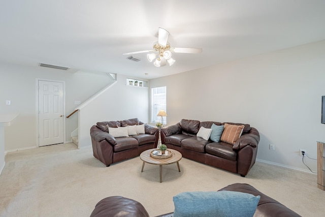 carpeted living room featuring ceiling fan