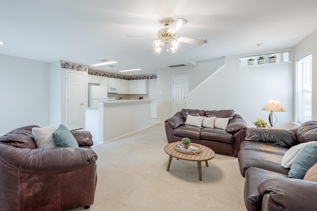 living room with ceiling fan and light colored carpet