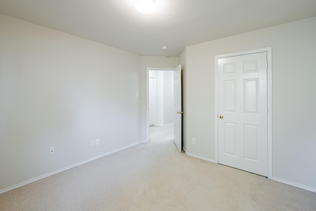 unfurnished bedroom featuring light carpet