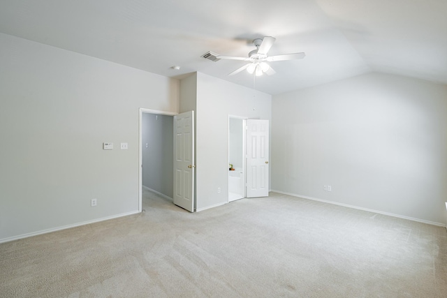 unfurnished bedroom featuring ceiling fan, vaulted ceiling, and light colored carpet