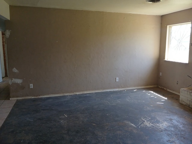 spare room with concrete floors