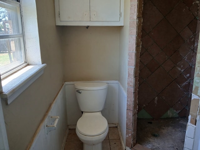 bathroom with toilet and tile patterned floors