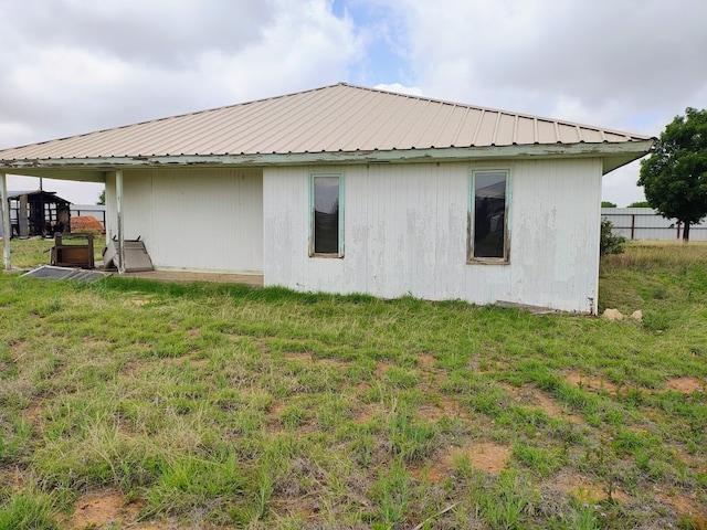 view of side of home featuring a yard