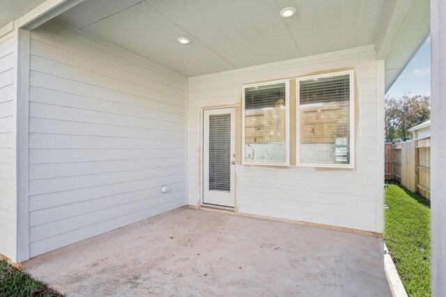 property entrance featuring a patio area