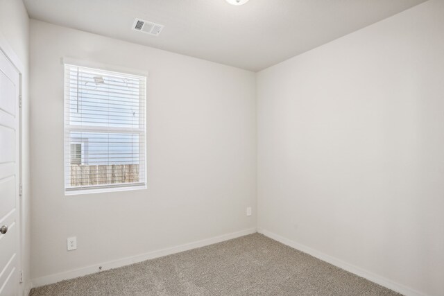 carpeted spare room with a healthy amount of sunlight