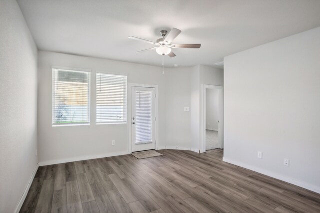 empty room with ceiling fan and hardwood / wood-style floors