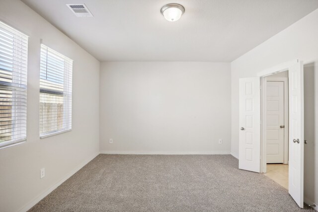 unfurnished room with light carpet