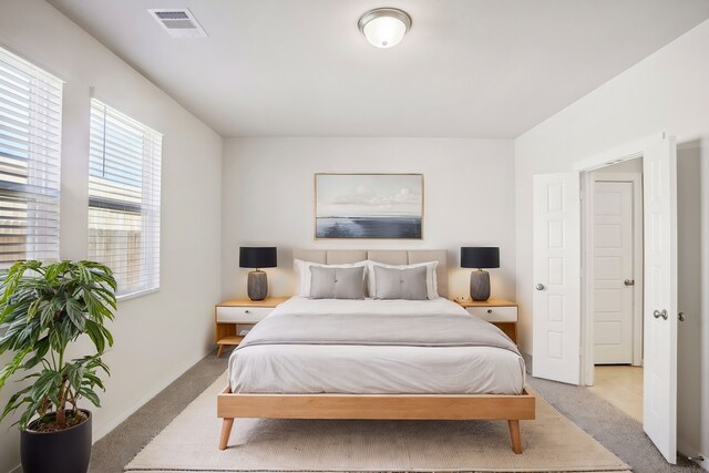 bedroom featuring light carpet