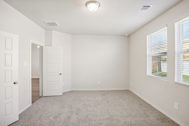 spare room featuring light colored carpet