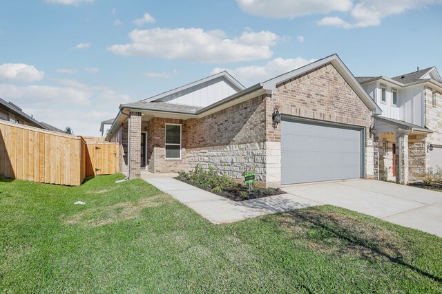 view of front of property featuring a garage and a front yard