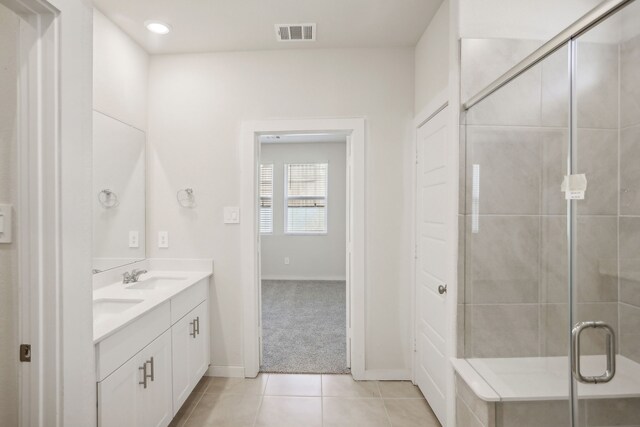 bathroom featuring vanity, walk in shower, and tile patterned floors