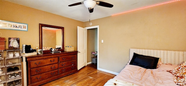 bedroom with hardwood / wood-style floors and ceiling fan