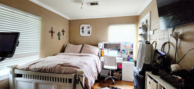 bedroom featuring ornamental molding and hardwood / wood-style floors