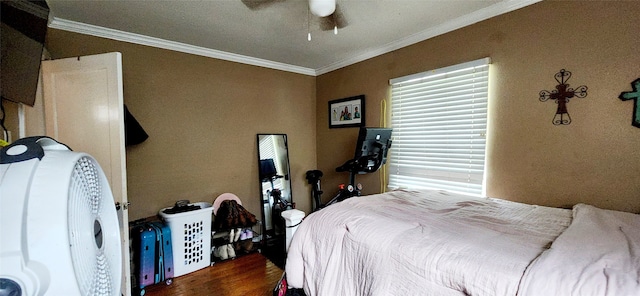 bedroom with ornamental molding, ceiling fan, and dark hardwood / wood-style floors