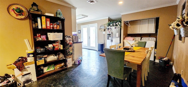 dining room with washing machine and dryer, ornamental molding, and french doors