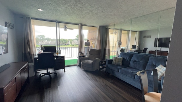 living room featuring a textured ceiling, floor to ceiling windows, and dark hardwood / wood-style floors