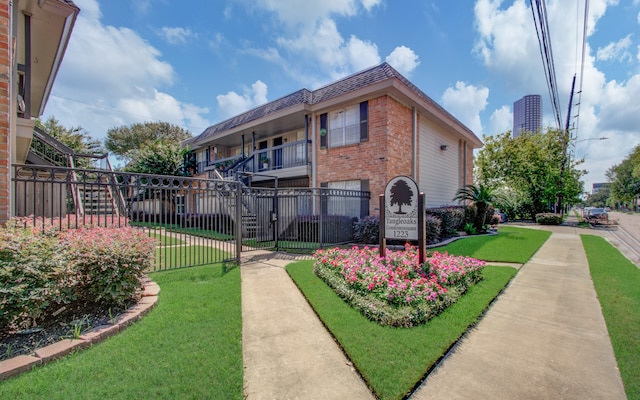 back of property featuring a yard and a balcony