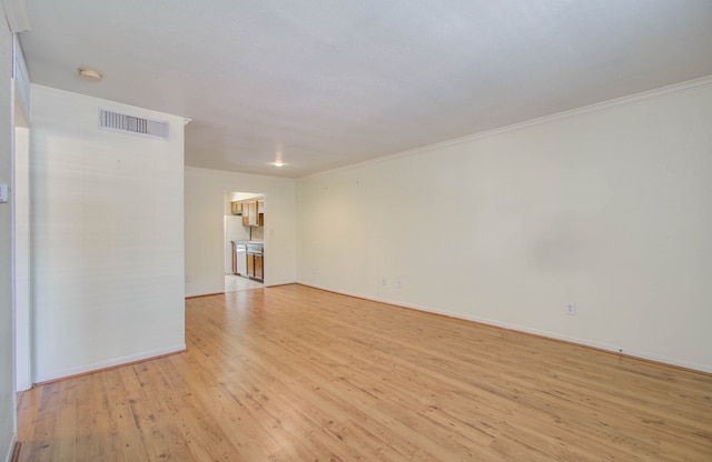 unfurnished room featuring crown molding and light hardwood / wood-style flooring