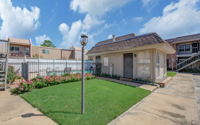 exterior space featuring a yard and a pool