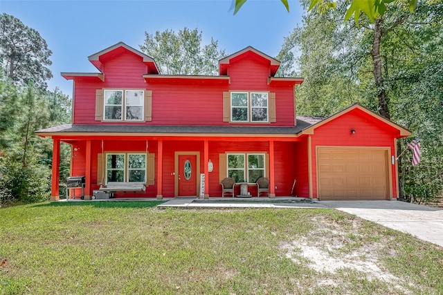 view of front of home featuring a garage, covered porch, and a front yard