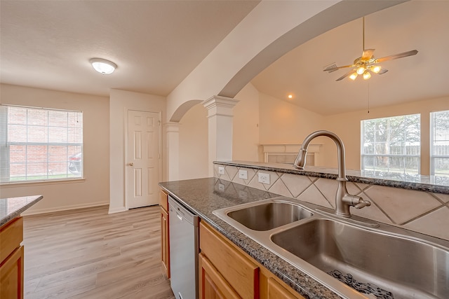 kitchen featuring dishwasher, decorative columns, light hardwood / wood-style floors, sink, and ceiling fan