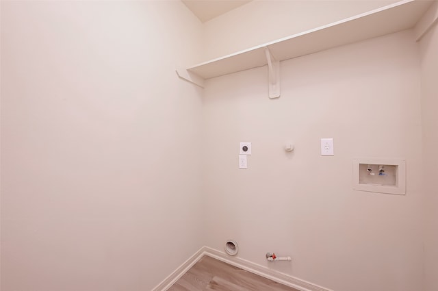 clothes washing area featuring washer hookup, hookup for an electric dryer, gas dryer hookup, and light hardwood / wood-style flooring