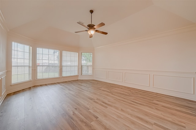 empty room featuring light wood-type flooring, vaulted ceiling, and ceiling fan